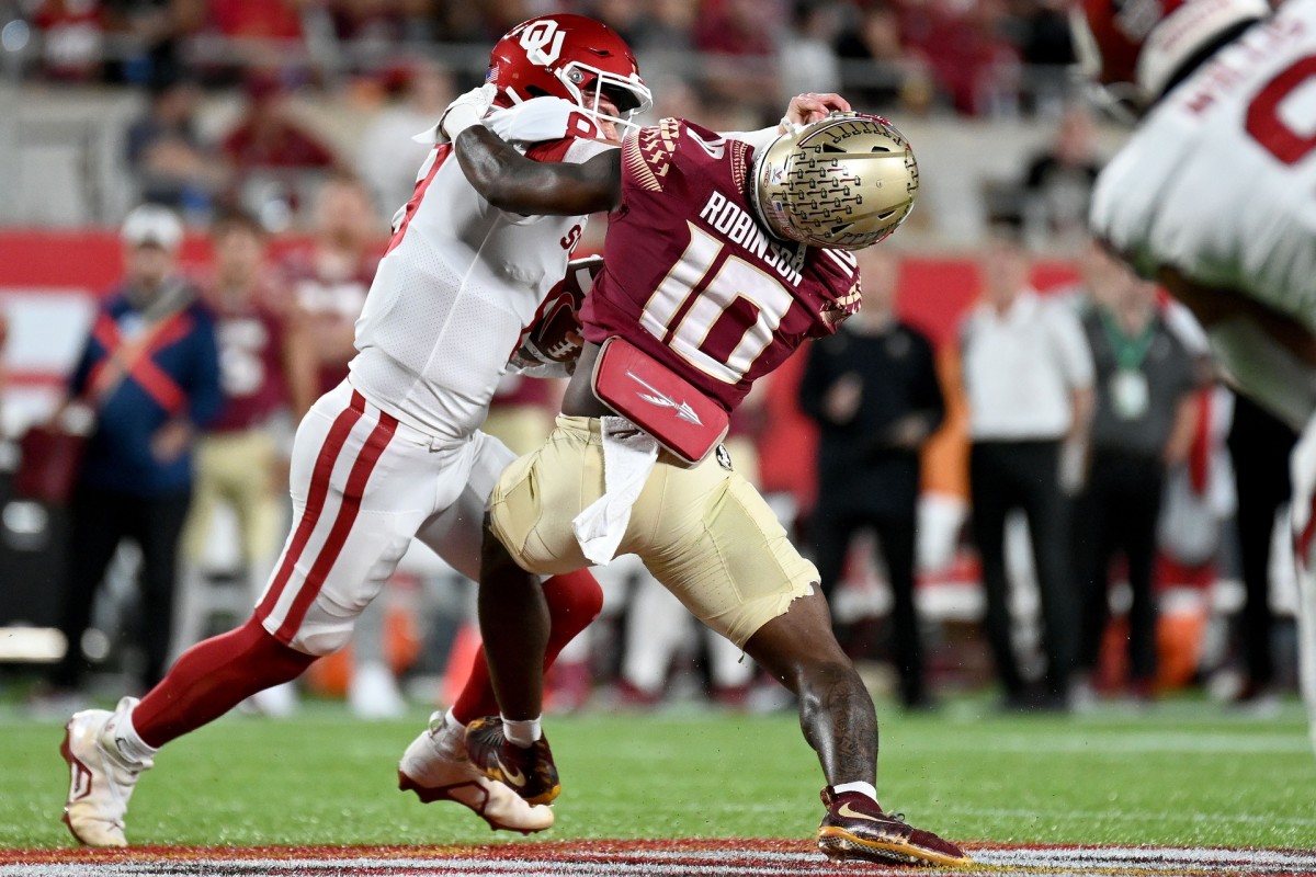Dec 29, 2022; Orlando, Florida, USA; Oklahoma Sooners quarterback Gabriel Dillon (8) gets sacked by Florida State Seminoles defensive back Jammie Robinson (10) in the first quarter in the 2022 Cheez-It Bowl at Camping World Stadium. Mandatory Credit: Jonathan Dyer-USA TODAY Sports