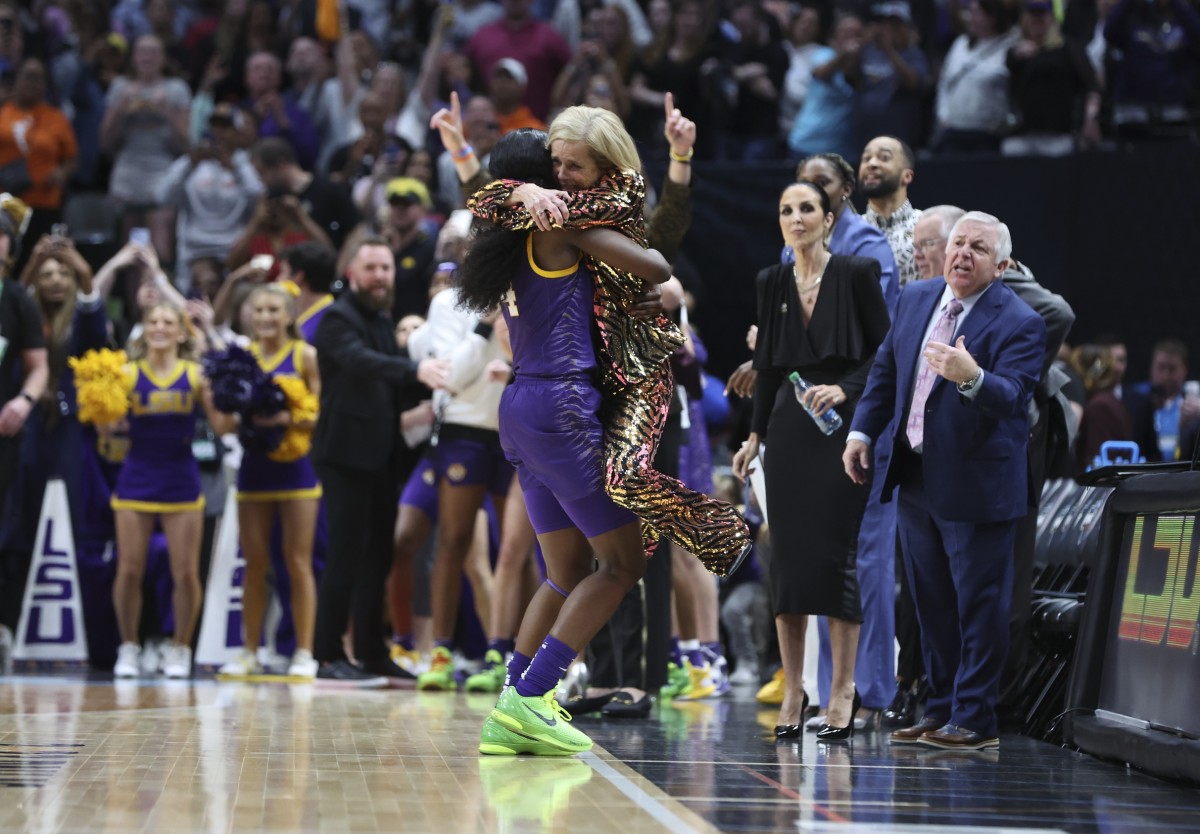 Apr 2, 2023; Dallas, TX, USA; LSU Lady Tigers guard Flau'jae Johnson (4) lifts up LSU Lady Tigers head coach Kim Mulkey during the second half against the Iowa Hawkeyes during the final round of the Women's Final Four NCAA tournament at the American Airlines Center.