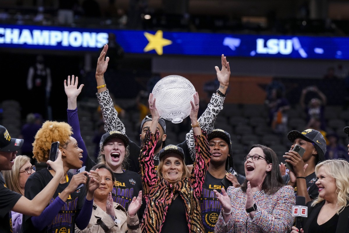 Apr 2, 2023; Dallas, TX, USA; LSU Lady Tigers head coach Kim Mulkey celebrates with a trophy after defeating the Iowa Hawkeyes during the final round of the Women's Final Four NCAA tournament at the American Airlines Center.