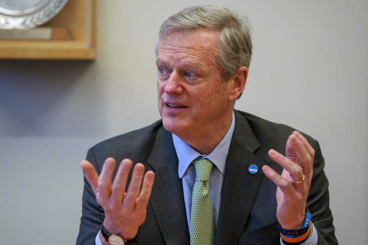 New NCAA president Charlie Baker gestures with his hands while talking