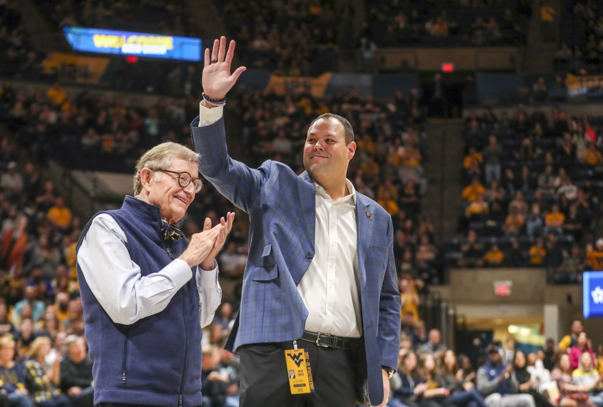 Dec 18, 2022; Morgantown, West Virginia, USA; West Virginia University President Gordon Gee welcomes new West Virginia Mountaineers Athletic Director Wren Baker during the first half against the Buffalo Bulls at WVU Coliseum.