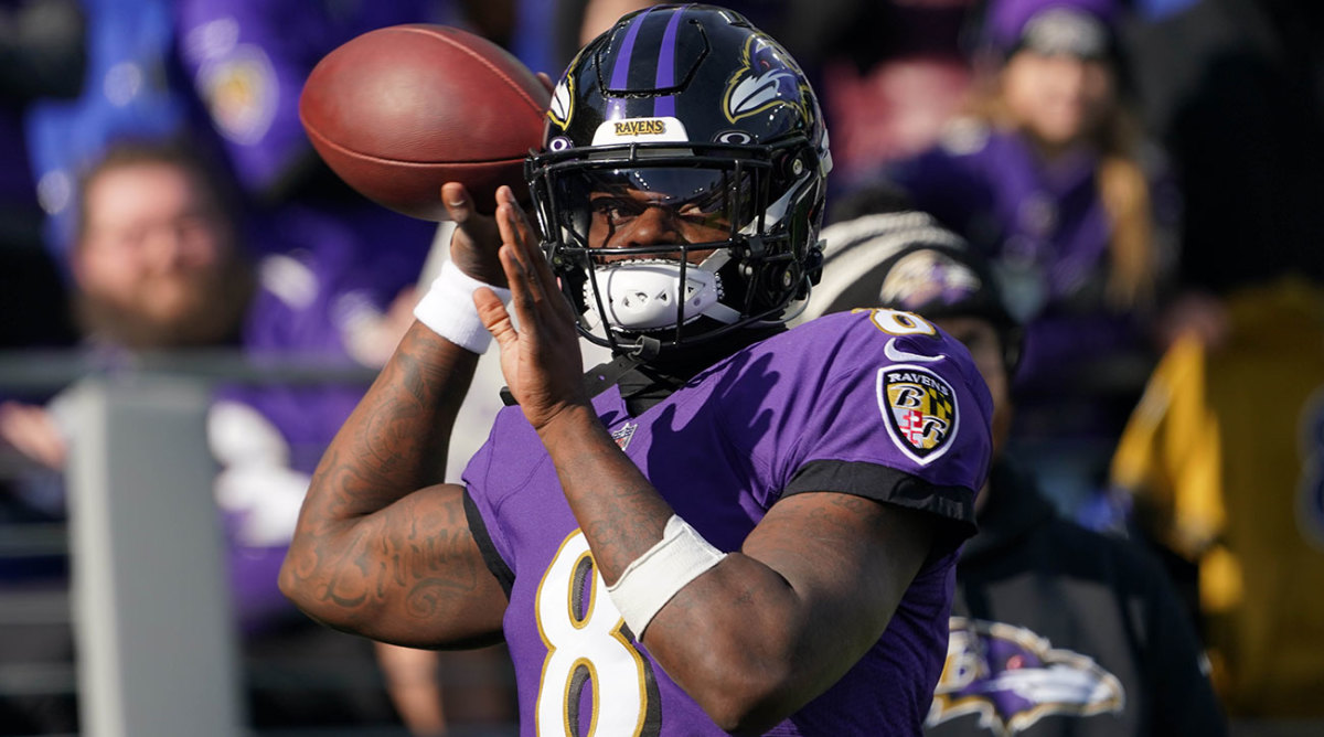 Lamar Jackson throws a ball during pregame warmups