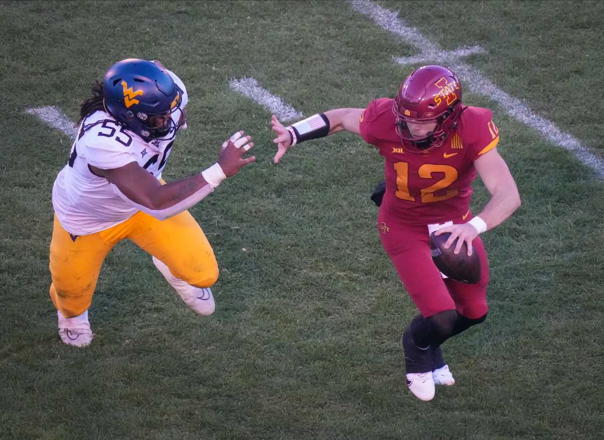 Iowa State quarterback Hunter Dekkers (12) scrambles to move out of the reach of West Virginia defensive lineman Dante Stills (55) in the fourth quarter during a NCAA football game at Jack Trice Stadium in Ames on Saturday, Nov. 5, 2022. Iowastatevswvu 202201105 Bh