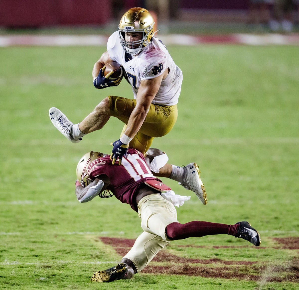 Notre Dame Fighting tight end Michael Mayer (87) jumps over Florida State defensive back Jammie Robinson (10). © Alicia Devine/Tallahassee Democrat via Imagn Content Services, LLC