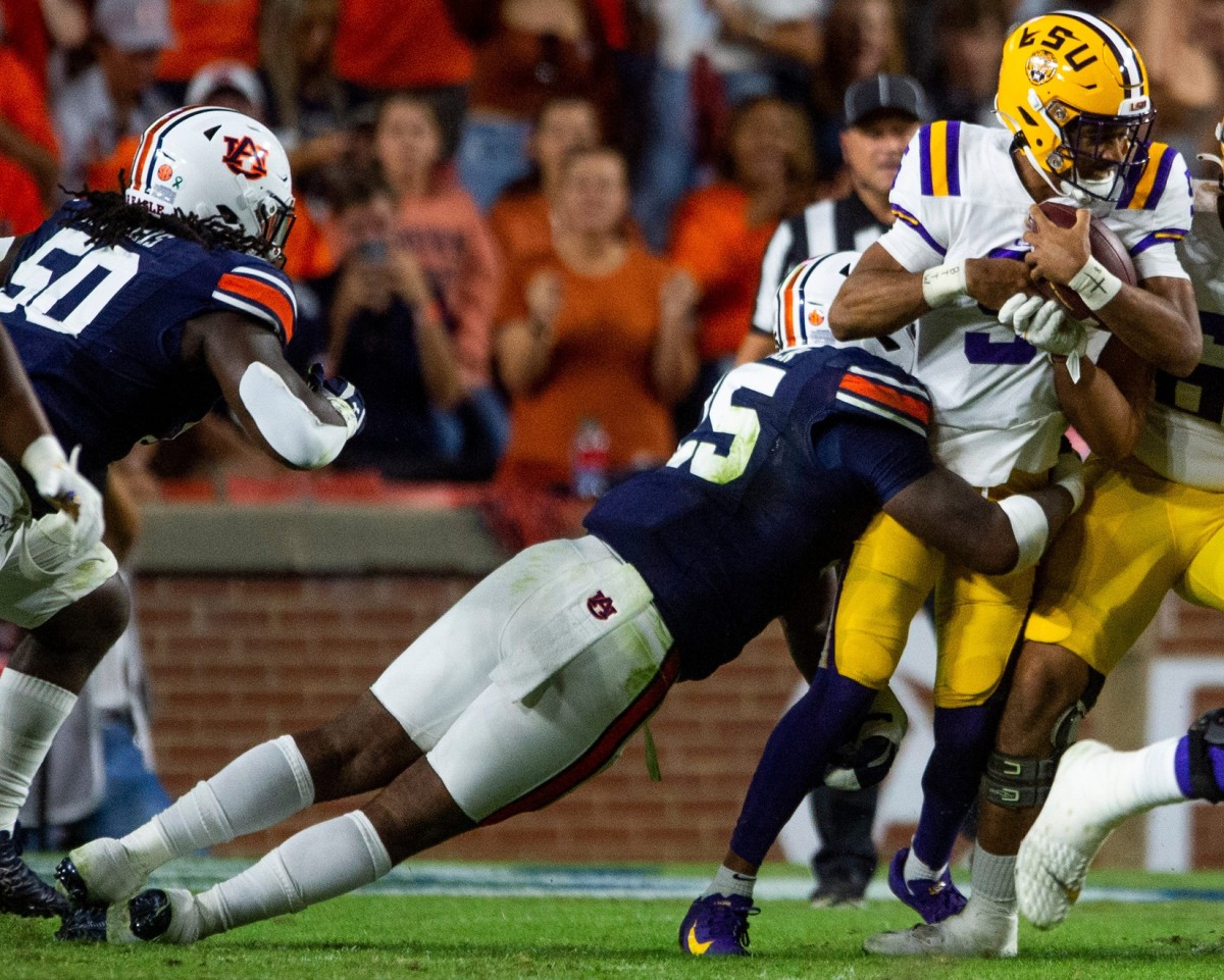 LSU Tigers quarterback Jayden Daniels (5) is stopped by Auburn Tigers defensive end Colby Wooden (25) as the Auburn Tigers take on the LSU Tigers at Jordan-Hare Stadium in Auburn, Ala., on Saturday, Oct. 1, 2022. Aulsu23