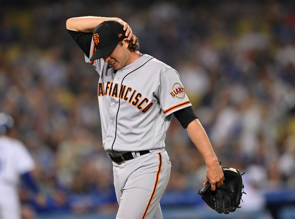 SF Giants relief pitcher Sam Long returns to the dugout after giving up a grand slam against the Dodgers. (2022)