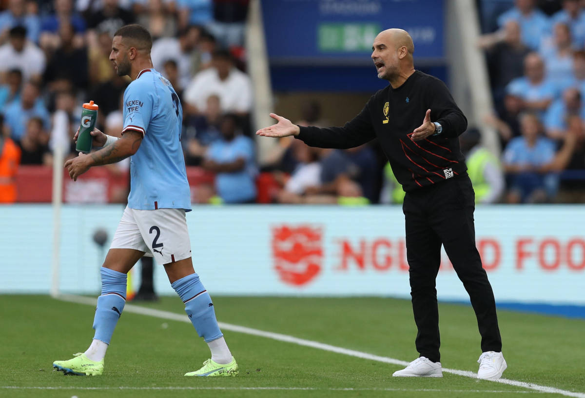 Manchester City manager Pep Guardiola pictured (right) talking to Kyle Walker (left) during the 2022 Community Shield game against Liverpool