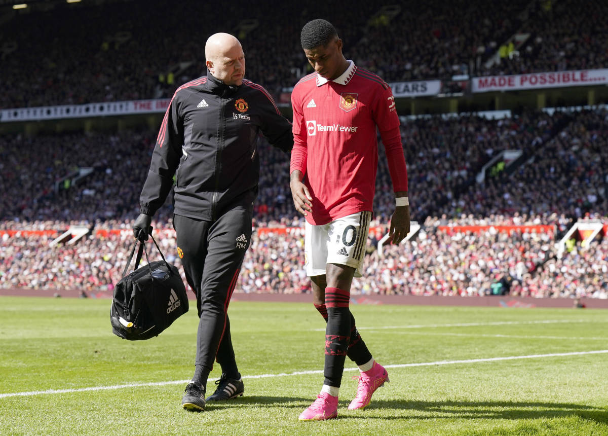 Manchester United striker Marcus Rashford pictured (right) walking off the field after injuring his groin during a 2-0 win over Everton in April 2023