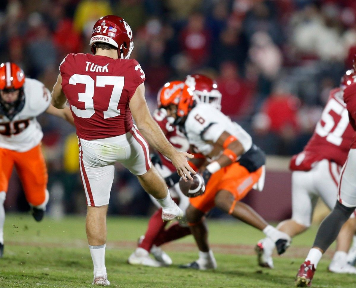 Oklahoma's Michael Turk (37) punts a ball in the second half during the Bedlam college football game between the University of Oklahoma Sooners (OU) and the Oklahoma State University Cowboys (OSU) at Gaylord Family-Oklahoma Memorial Stadium, in Norman, Okla., Saturday, Nov., 19, 2022. Presto Id