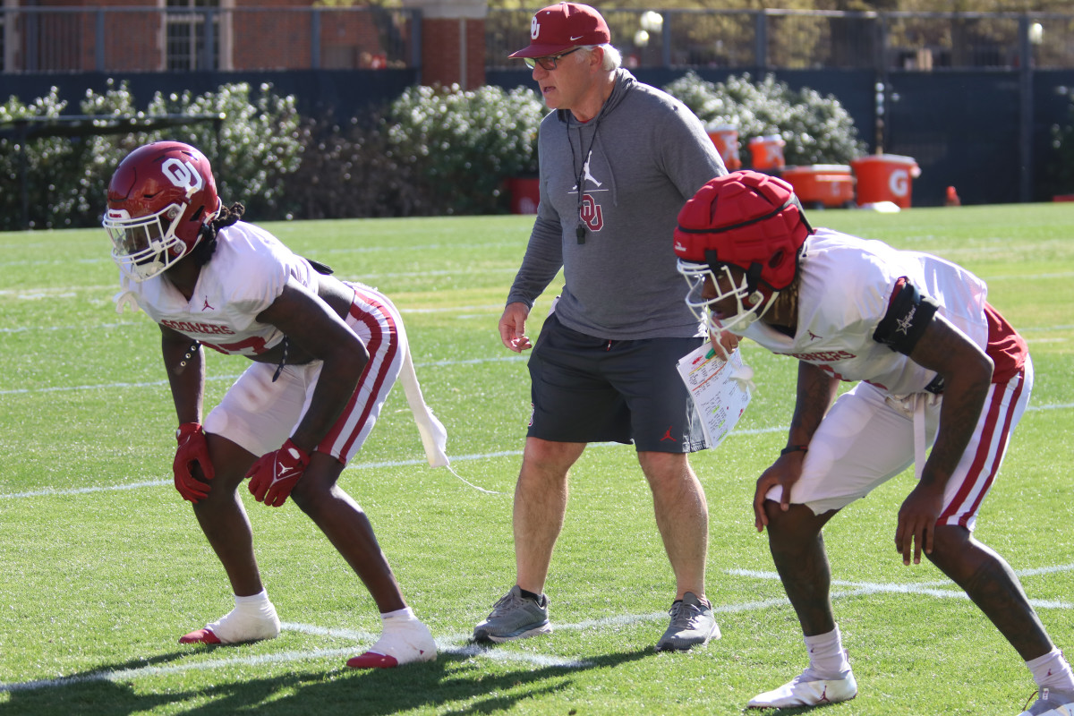 Justin Harrington (left) and Dasan McCullough (right) working with defensive coordinator Ted Roof