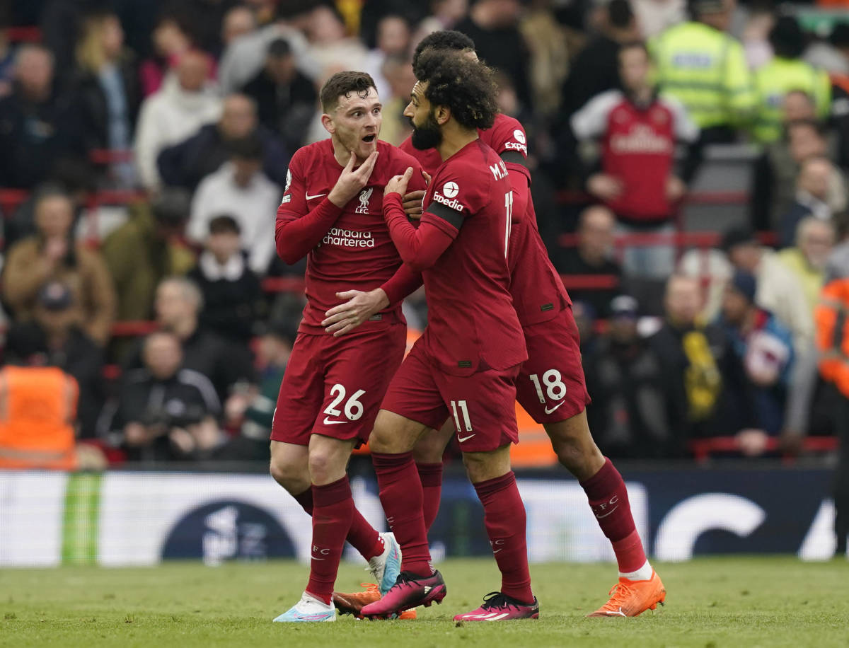 Andy Robertson pictured (left) holding his chin after being caught by the elbow of assistant referee Constantine Hatzidakis (not in shot) during Liverpool's 2-2 draw with Arsenal in April 2023