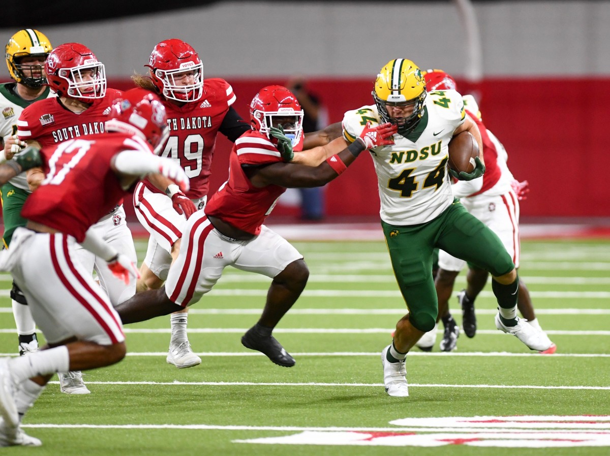 North Dakota State s Hunter Luepke holds off a South Dakota player during a football game on Saturday, September 24, 2022, at the DakotaDome in Vermillion. Usd Vs Ndsu 001