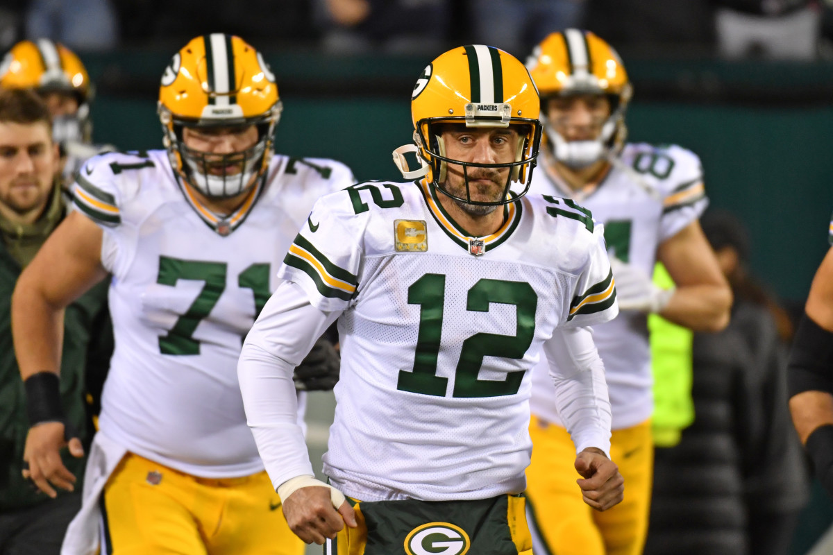 Quarterback Aaron Rodgers leads the Packers' offense onto the field