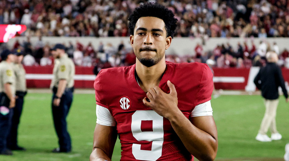 Bryce Young walks off the field after a win with no helmet on