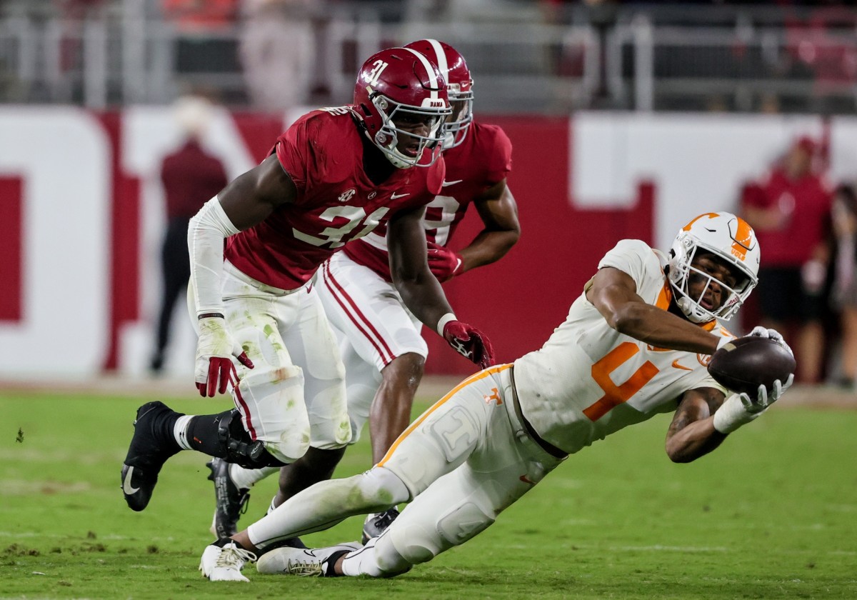 Oct 23, 2021; Tennessee Volunteers receiver Cedric Tillman (4) catches a pass against Alabama Crimson Tide linebacker Will Anderson Jr. (31). Mandatory Credit: Butch Dill-USA TODAY