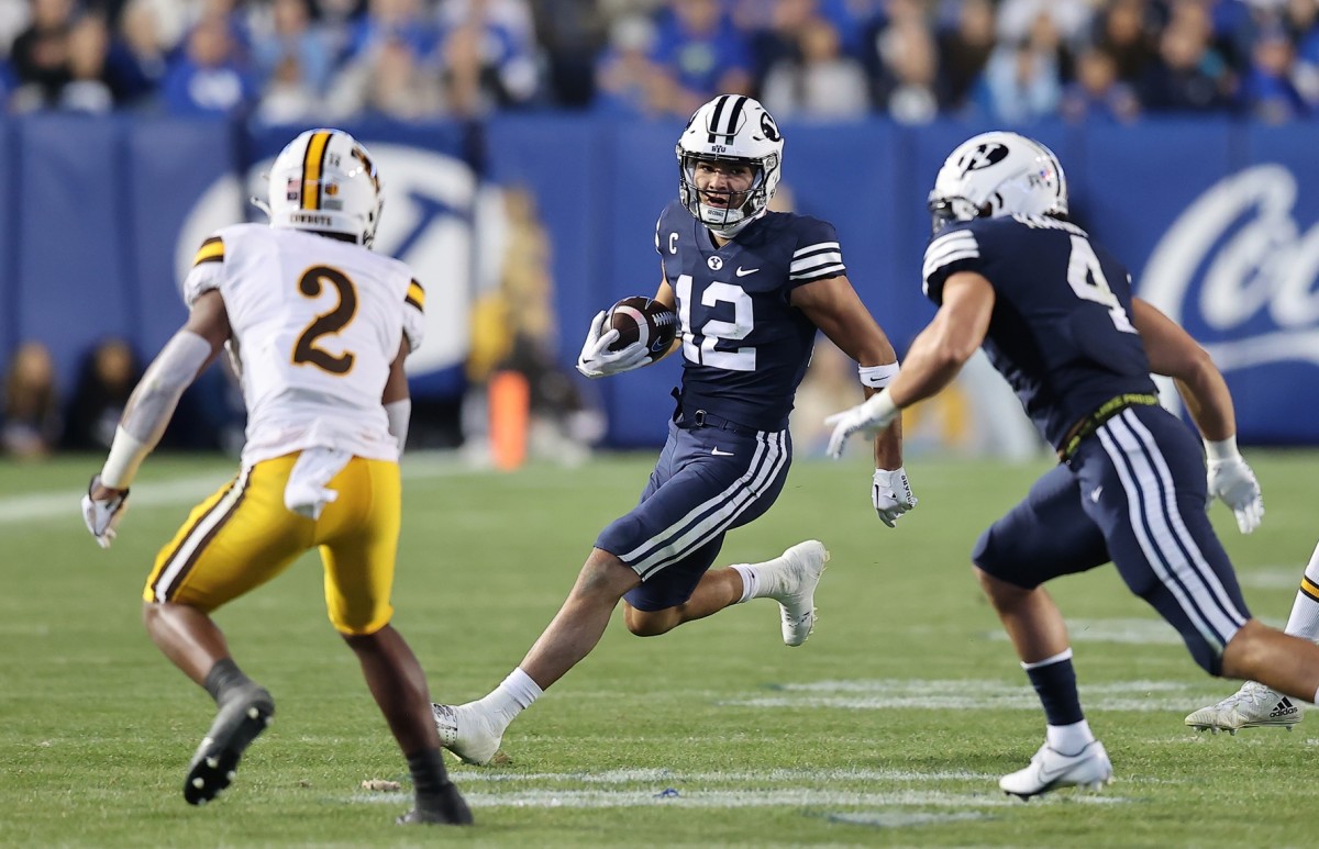 Sep 24, 2022; Provo, Utah, USA; Brigham Young Cougars wide receiver Puka Nacua (12) runs after a catch in the fourth quarter against the Wyoming Cowboys at LaVell Edwards Stadium. Mandatory Credit: Rob Gray-USA TODAY Sports
