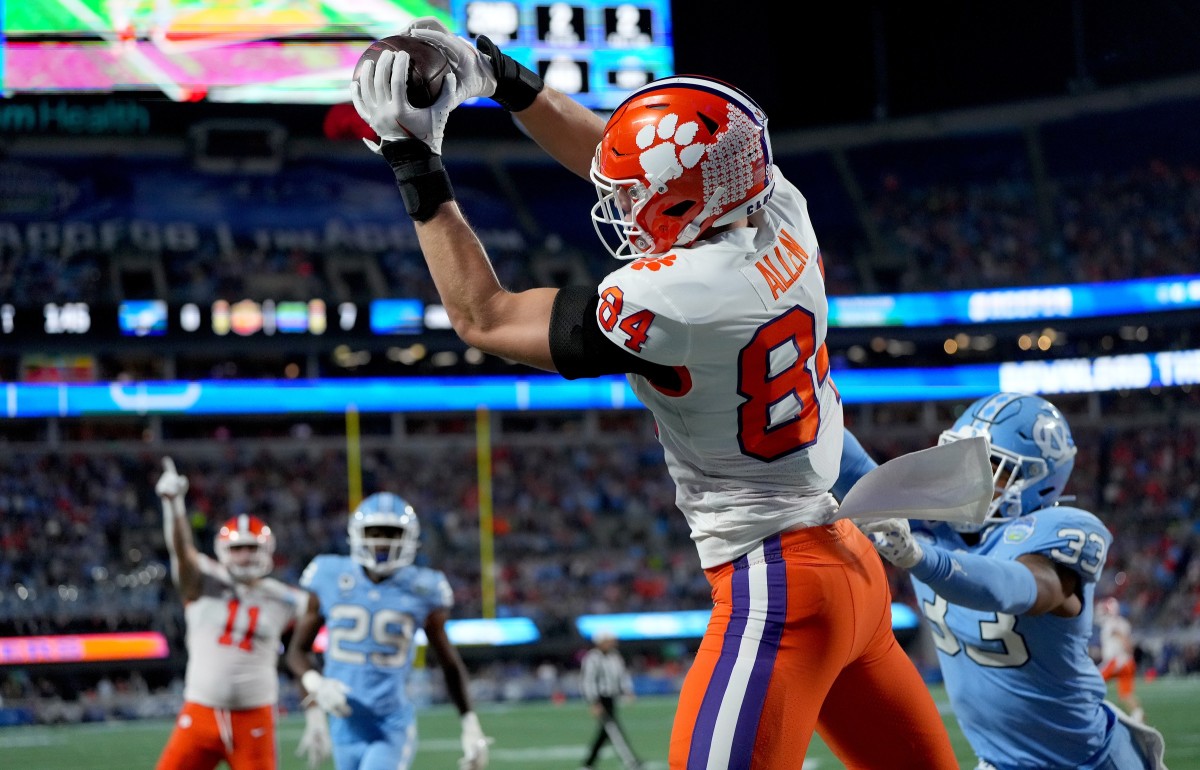 Dec 3, 2022; Charlotte, North Carolina, USA; Clemson Tigers tight end Davis Allen (84) catches a touchdown in front of North Carolina Tar Heels linebacker Cedric Gray (33) during the first quarter of the ACC Championship game at Bank of America Stadium. Mandatory Credit: Bob Donnan-USA TODAY Sports
