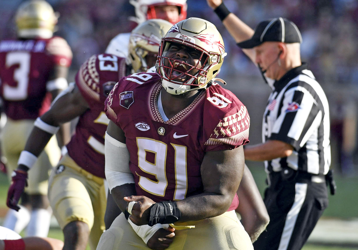 Florida State Seminoles defensive tackle Robert Cooper (91) celebrates after a play during the game against the Louisville Cardinals at Doak S. Campbell Stadium.