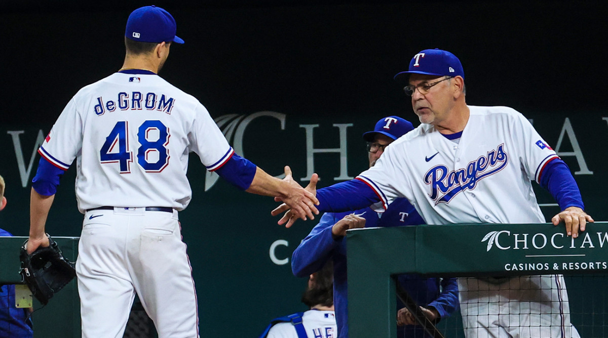 Rangers’ Jacob deGrom shakes manager Bruce Bochy’s hand after being taken out of a game.