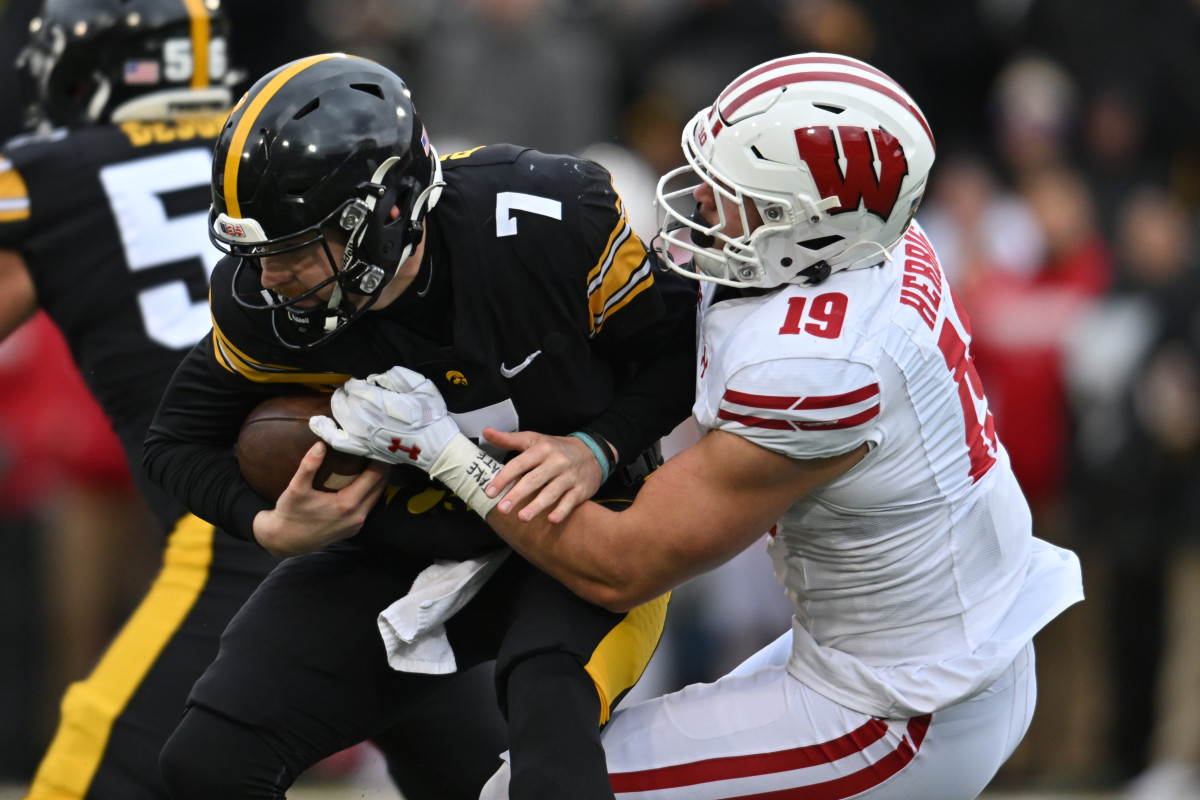 Wisconsin Badgers linebacker Nick Herbig (19) sacks Iowa Hawkeyes quarterback Spencer Petras (7) during the first quarter at Kinnick Stadium.
