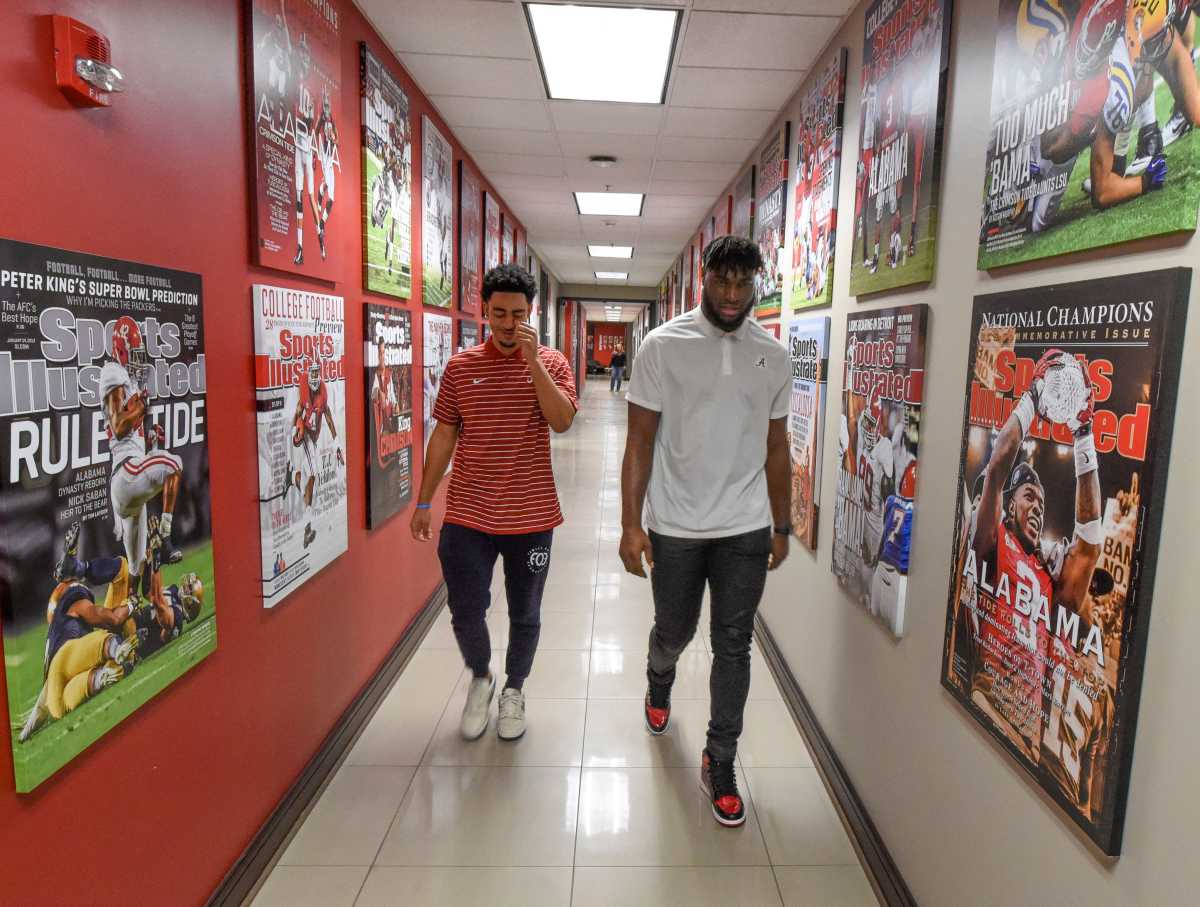 Jan 02, 2023; Tuscaloosa, AL, USA; Bryce Young and Will Anderson Jr. walk down a hallway lined with Sports Illustrated covers as they go to a press conference for University of Alabama juniors to announce their intentions to enter the NFL draft.