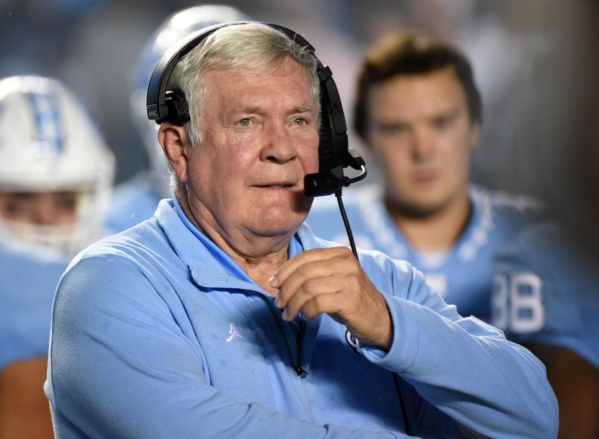 Mack Brown calls a play from the sidelines for UNC