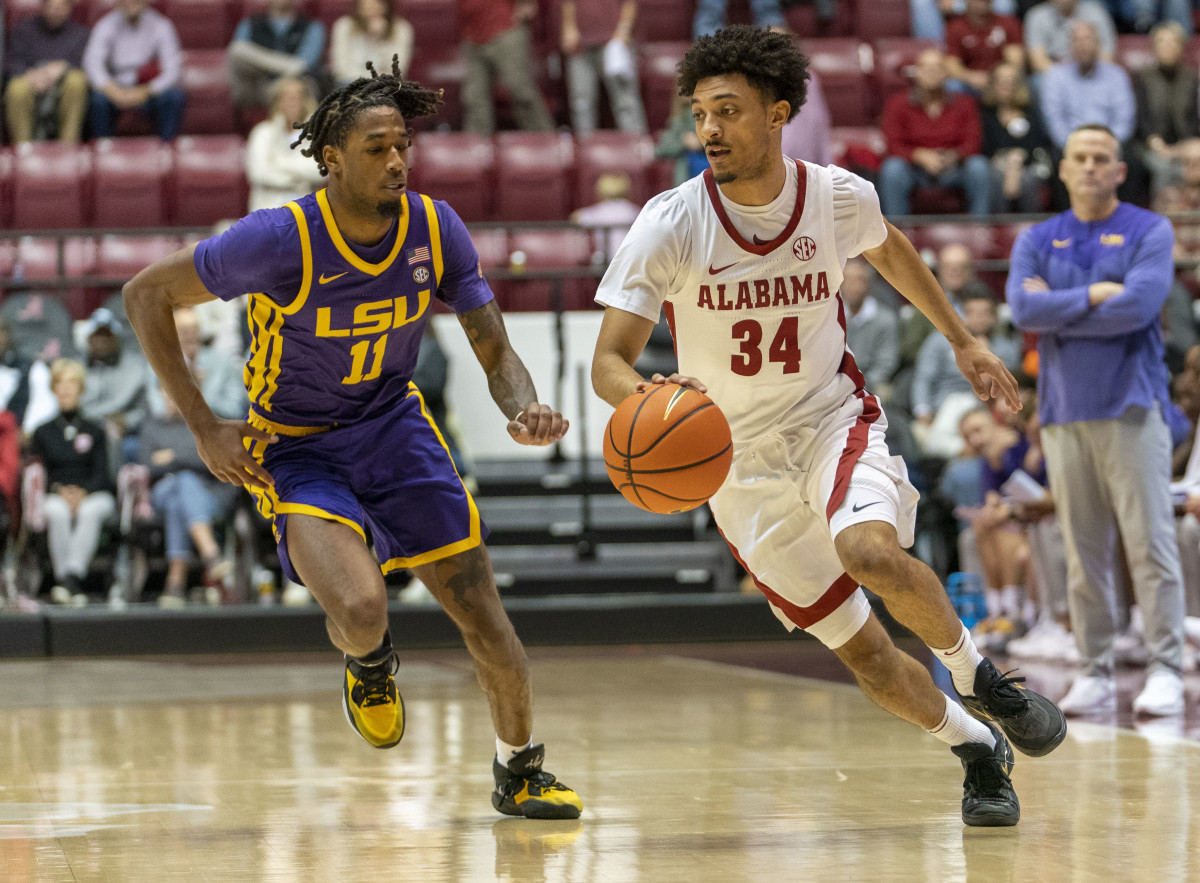 Jan 14, 2023; Tuscaloosa, Alabama, USA; Alabama Crimson Tide guard Jaden Quinerly (34) drives to the basket against LSU Tigers guard Justice Williams (11) during the second half at Coleman Coliseum. Mandatory Credit: Marvin Gentry-USA TODAY Sports