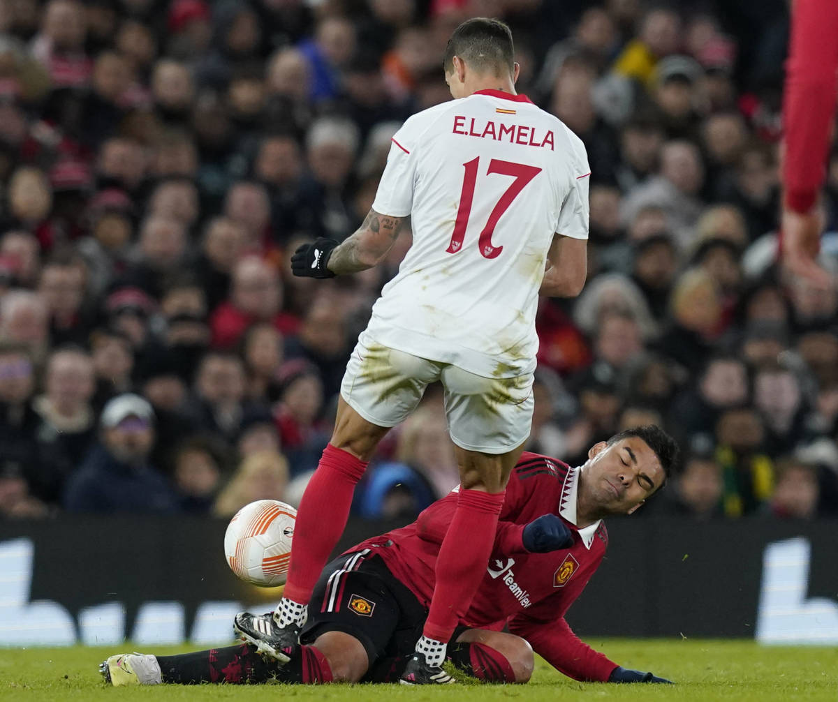 Sevilla forward Erik Lamela pictured fouling Manchester United midfielder Casemiro during a Europa League game in April 2023