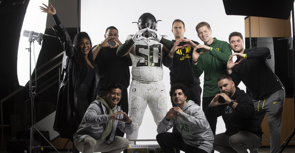 Gray poses with the Oregon staff.