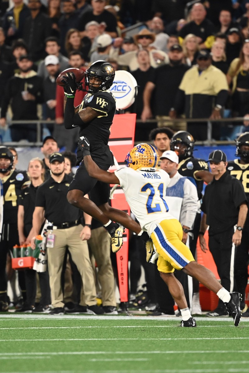 Dec 4, 2021; Wake Forest Demon Deacons wide receiver A.T. Perry (9) makes a catch as Pittsburgh Panthers defensive back Damarri Mathis (21) defends in the the ACC championship game. Mandatory Credit: Bob Donnan-USA TODAY Sports