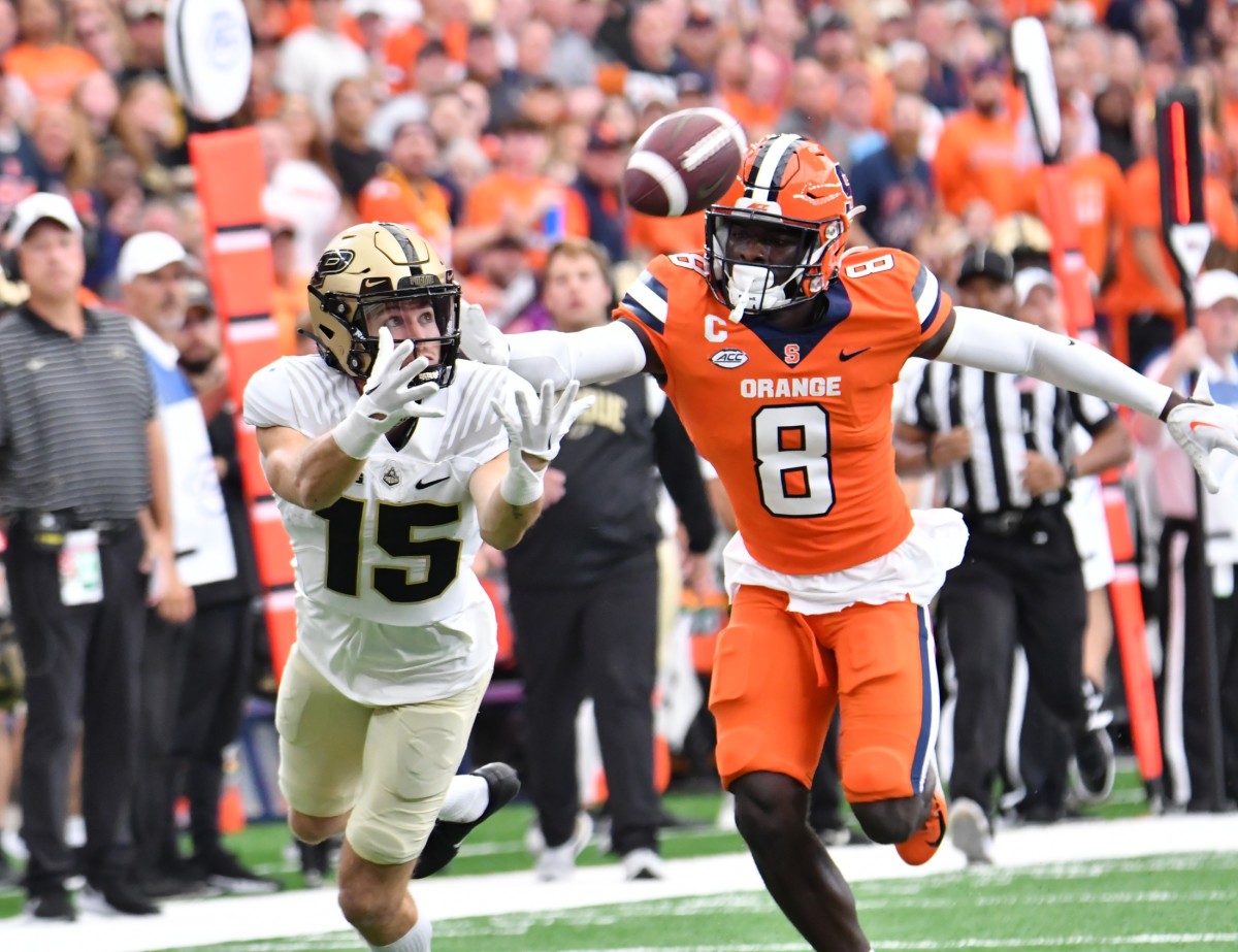 Sep 17, 2022; Syracuse, New York, USA; Purdue Boilermakers wide receiver Charlie Jones (15) reaches for a pass as Syracuse Orange defensive back Garrett Williams (8) chases in the first quarter at JMA Wireless Dome. Mandatory Credit: Mark Konezny-USA TODAY Sports
