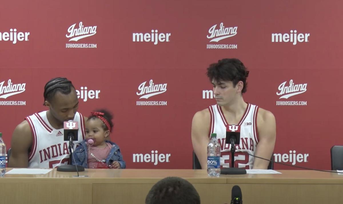 Indiana guard Tamar Bates (left) sits with daughter Leilani while Trey Galloway looks on during a press conference following the Hoosiers' win over Michigan State in January. (IU Athletics)