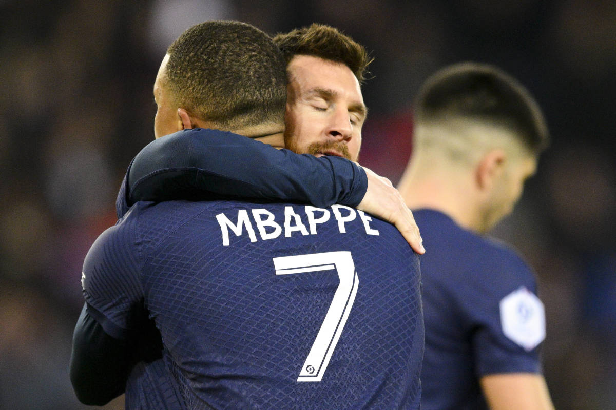 Lionel Messi and Kylian Mbappe pictured hugging after combining for a goal for PSG against Lens in April 2023