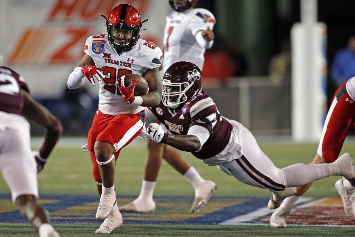 Texas Tech Red Raiders running backTahj Brooks (28) runs the ball as Mississippi State Bulldogs defensive linemen Cameron Young (93) attempts to make the tackle during the first half at Liberty Bowl Stadium.