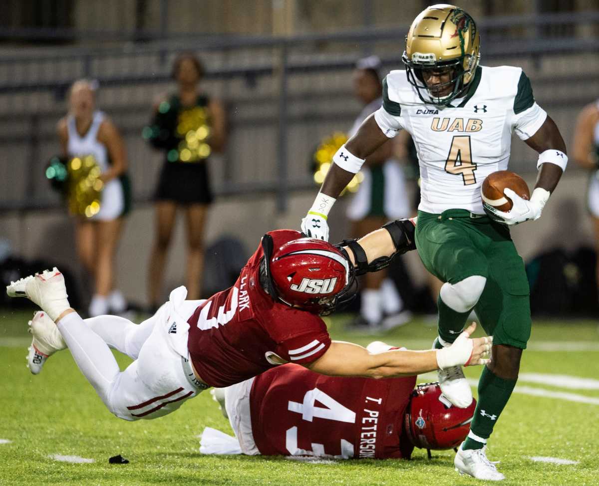 UAB Blazers defensive back Starling Thomas V (4) is tackled by Jacksonville State Gamecocks linebacker Marshall Clark (3) during the Montgomery Kickoff at Cramton Bowl in Montgomery, Ala., on Wednesday, Sept. 1, 2021. The UAB Blazers lead the Jacksonville State Gamecocks 10-0 at halftime.