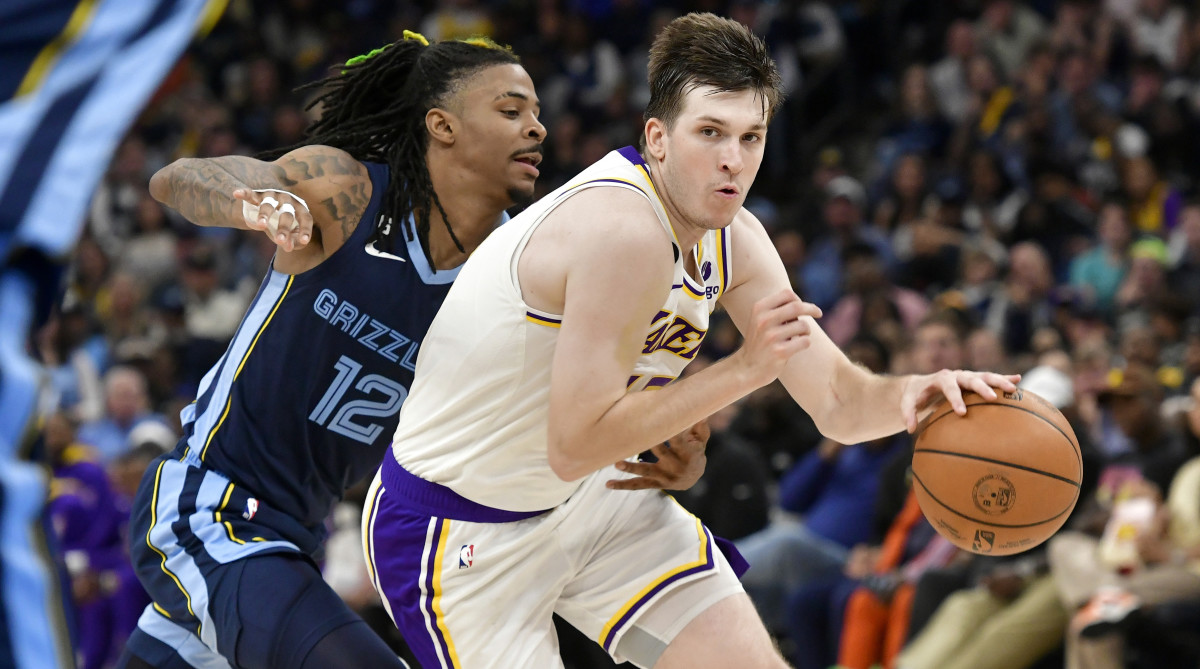 Lakers’ Austin Reaves dribbles around Ja Morant in Game 1
