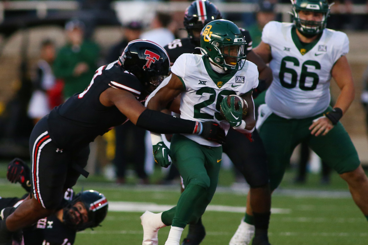 Oct 29, 2022; Lubbock, Texas, USA; Baylor Bears running back Richard Reese (29) rushes against Texas Tech Red Raiders defensive linebacker Tyree Wilson (19) in the first half at Jones AT&T Stadium and Cody Campbell Field.