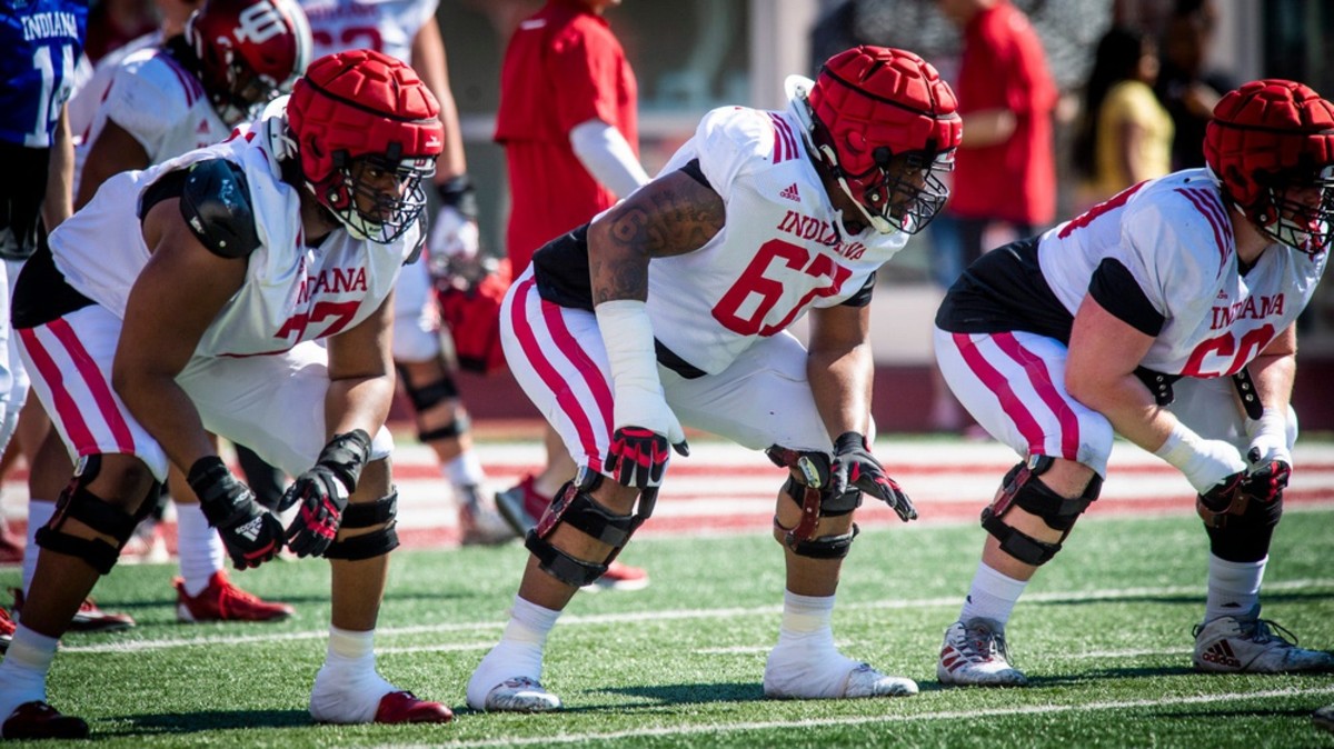 Indiana linemen Joshua Sales Jr. (77, left), Kalil Benson (67, middle) and Max Longman (60, right) prepare for a snap during Indiana football's Spring Football Saturday event at Memorial Stadium on Saturday, April 15, 2023.