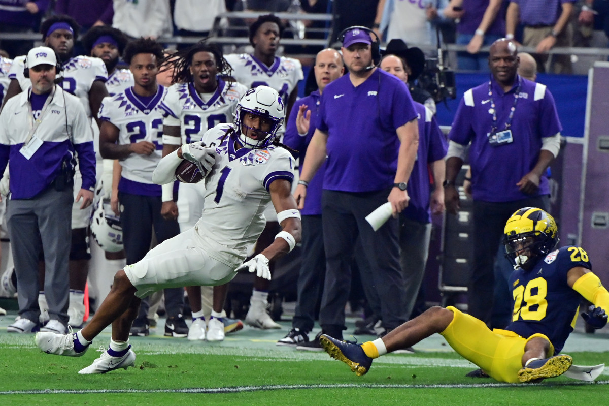 Dec 31, 2022; Glendale, Arizona, USA; TCU Horned Frogs wide receiver Quentin Johnston (1) makes a catch against Michigan Wolverines defensive back Quinten Johnson (28) in the second quarter of the 2022 Fiesta Bowl at State Farm Stadium.