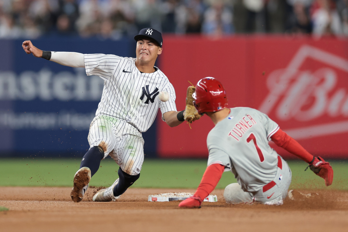 Philadelphia Phillies shortstop Trea Turner (7) steals second base while a Yankees player tries to catch the ball in time to tag him out