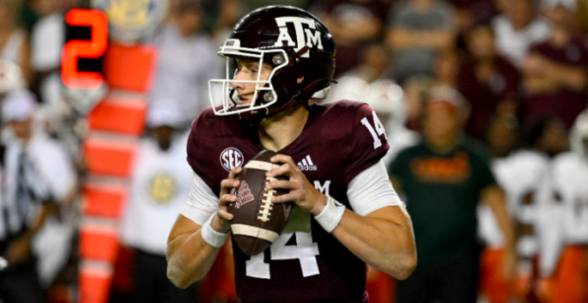 Texas A&M Aggies quarterback Max Johnson attempts a pass during a college football game in the SEC.