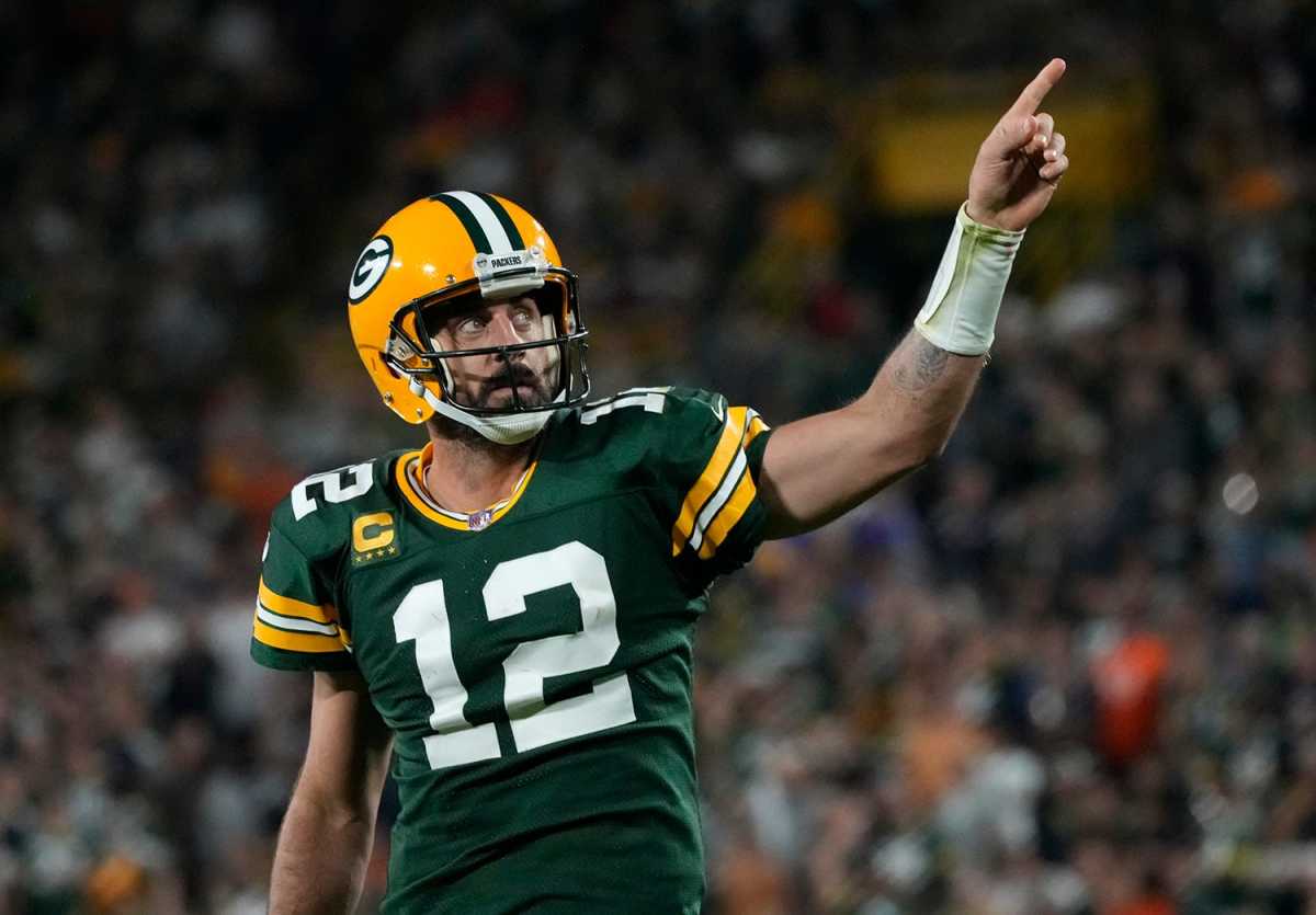 Aaron Rodgers points to the sky in a Packers uniform