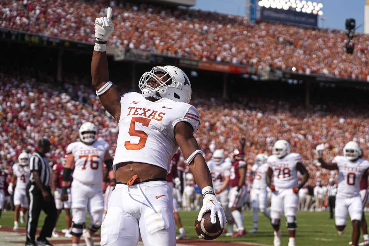 Texas running back Bijan Robinson looks up and points a finger to the sky in celebration