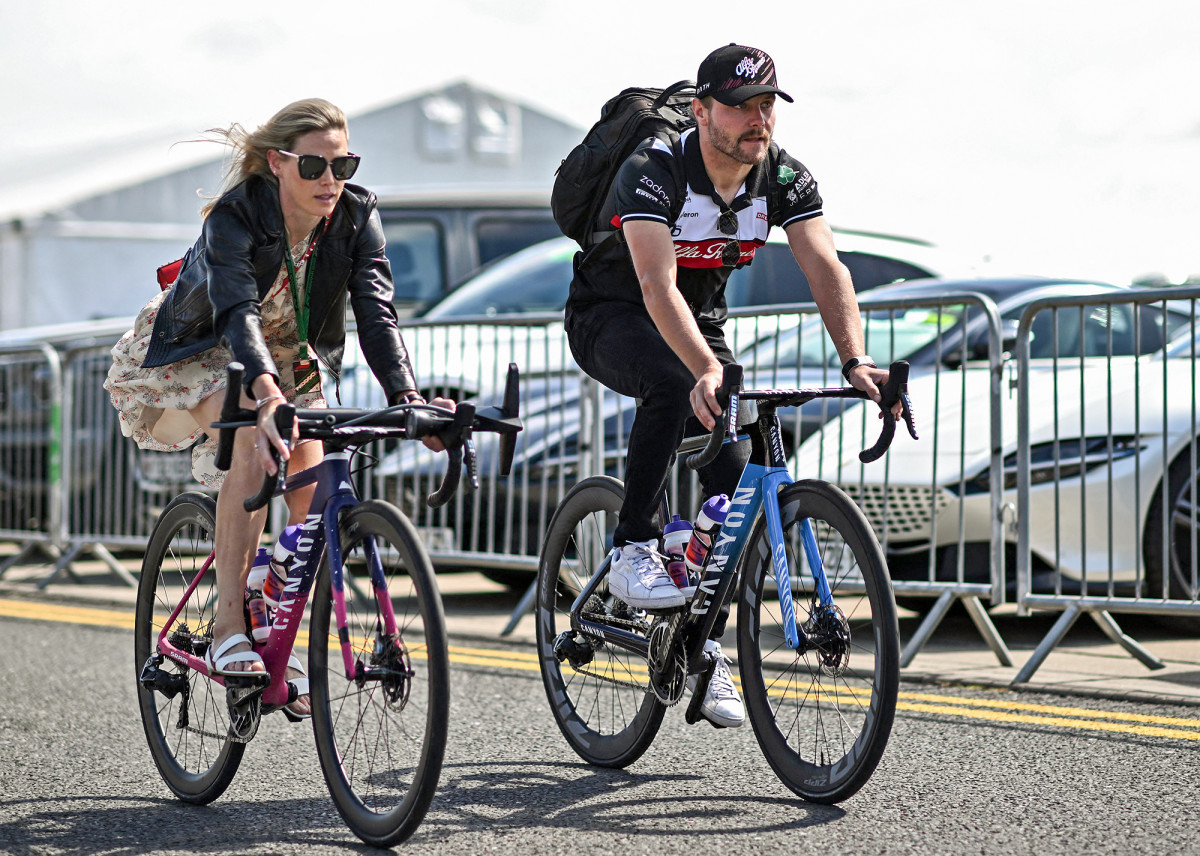 Valtteri Bottas has become outspoken on climate change and says, to get around, he now more often walks or bikes (here, with his girlfriend, Australian cyclist Tiffany Cromwell).