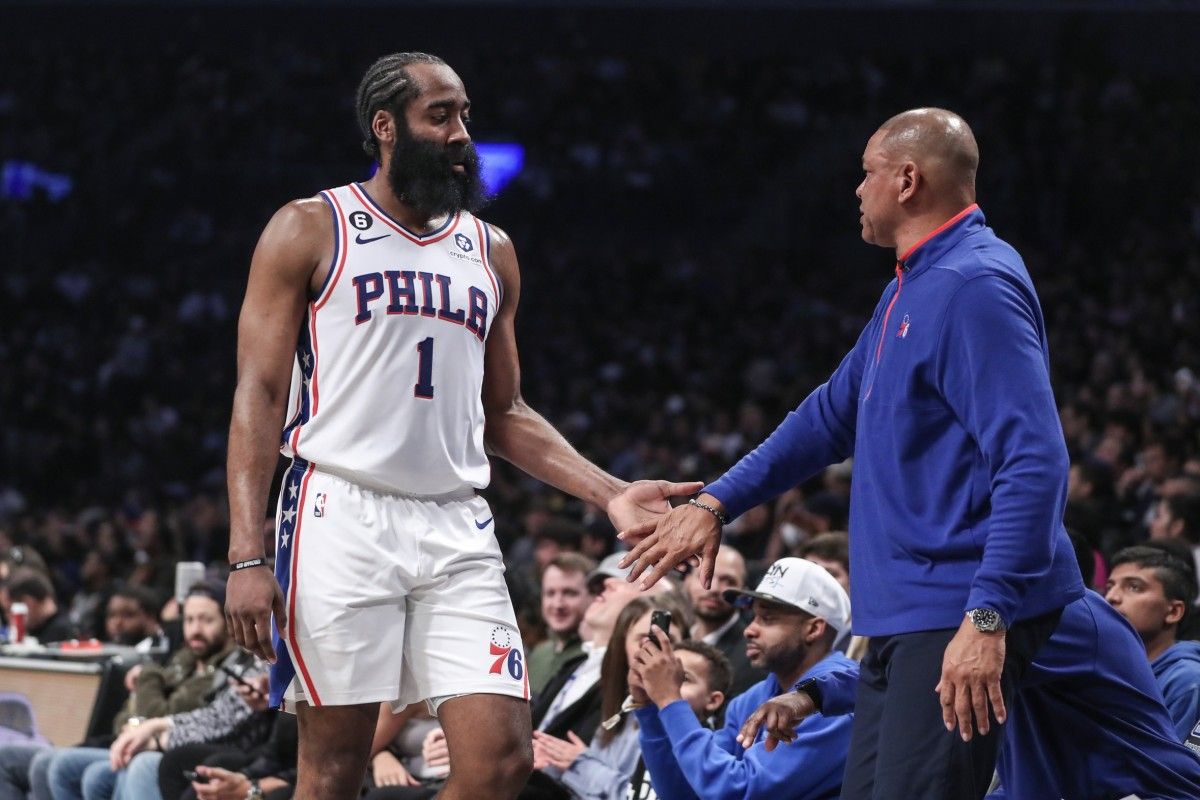 76ers head coach Doc Rivers shakes hands with James Harden