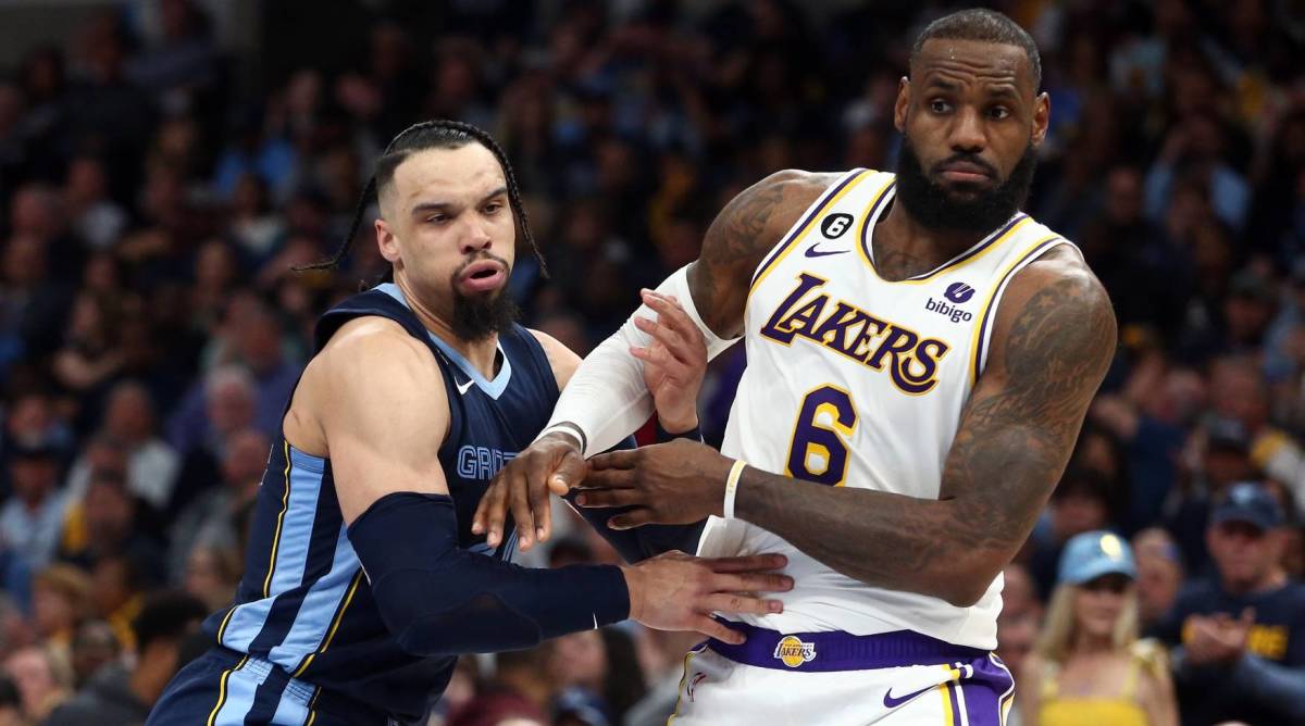 Lakers forward LeBron James and Grizzlies forward Dillon Brooks battle for a rebound in a game.