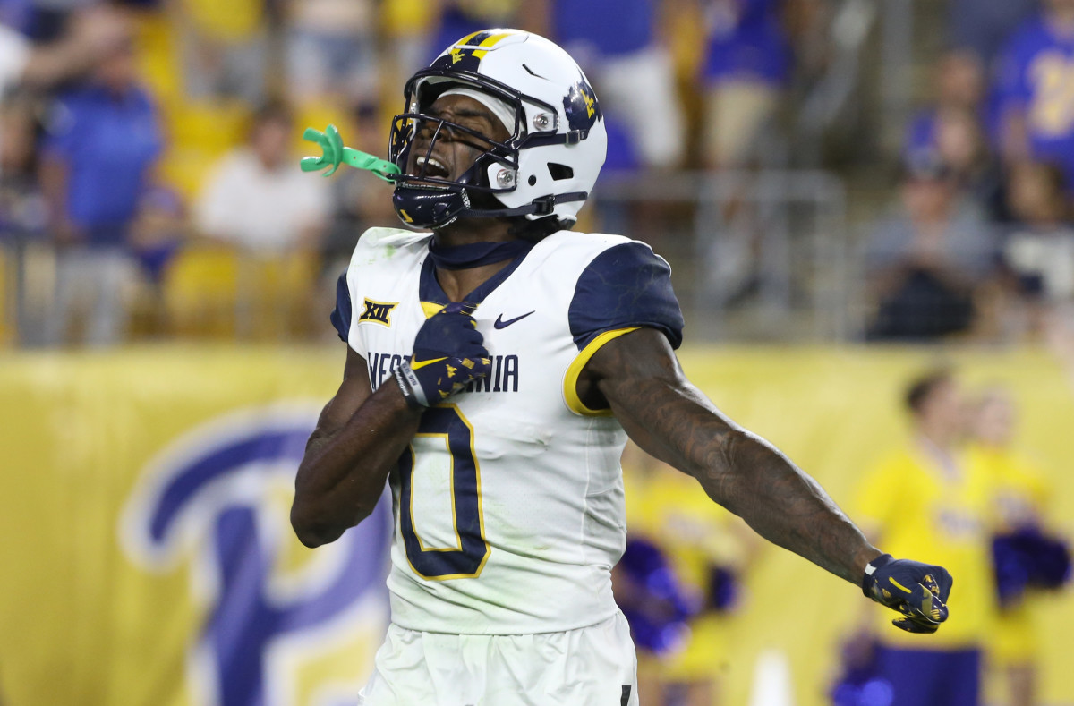 West Virginia Mountaineers wide receiver Bryce Ford-Wheaton (0) celebrates making a defensive stop on a punt return against the Pittsburgh Panthers during the fourth quarter at Acrisure Stadium.