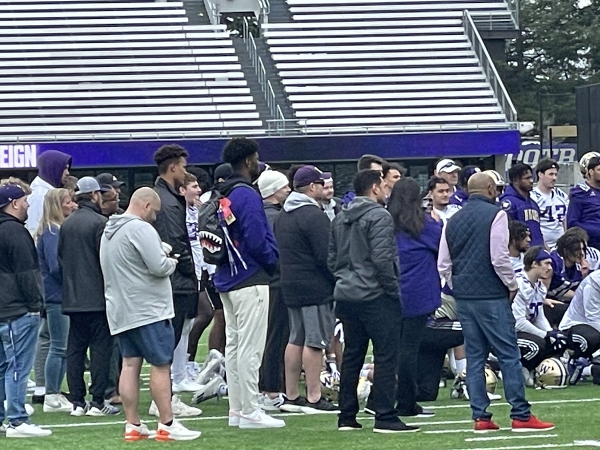 Austin Mack, tall guy in dark coat, and Elishah Jackett, tall guy in the purple sweatshirt, are signed Husky recruits who were visitors on Friday.