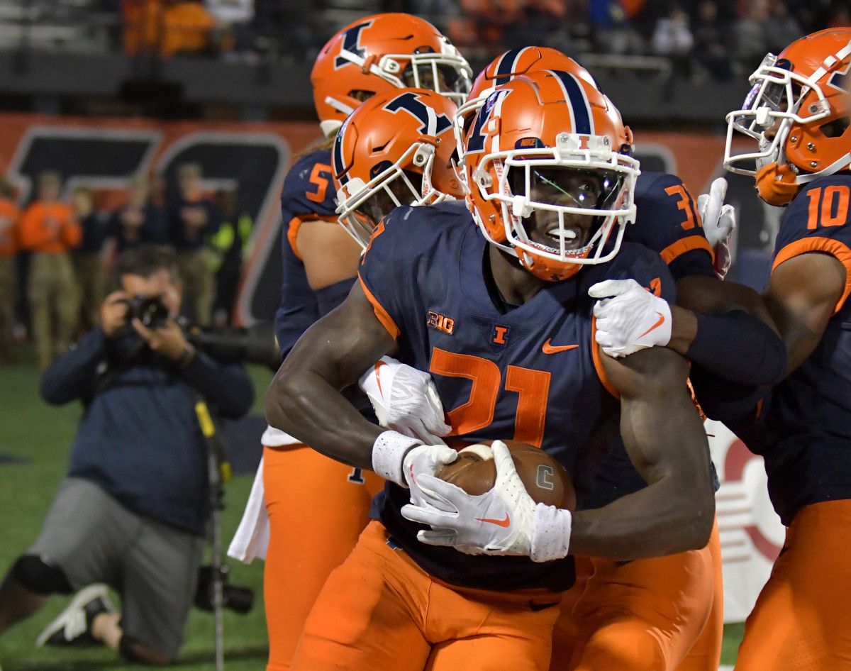Jartavius Martin (21) is congratulated by teammates after making an interception in the end zone against the Chattanooga Mocs