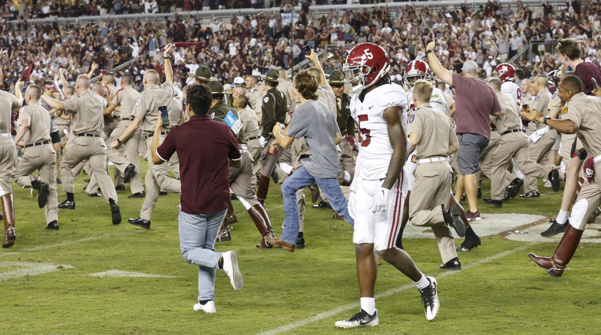 Alabama defensive back Jalyn Armour-Davis (5) leaves the field as Texas A&M fans storm the field after a game-winning field goal as time expired at Kyle Field